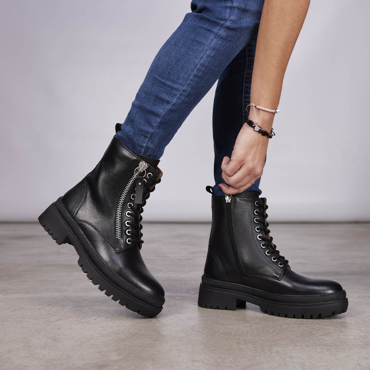 Mallaig women's black leather biker boots with track soles and a decorative metallic zip