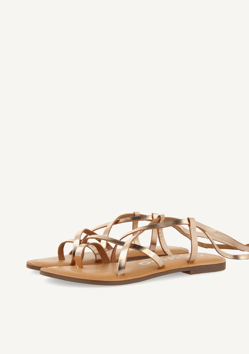 Lussat sandals with thin gold straps to tie around the leg