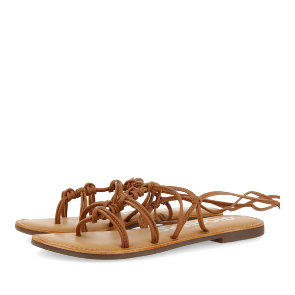 Mambai women's flat tan leather sandals with thin straps and decorative knots