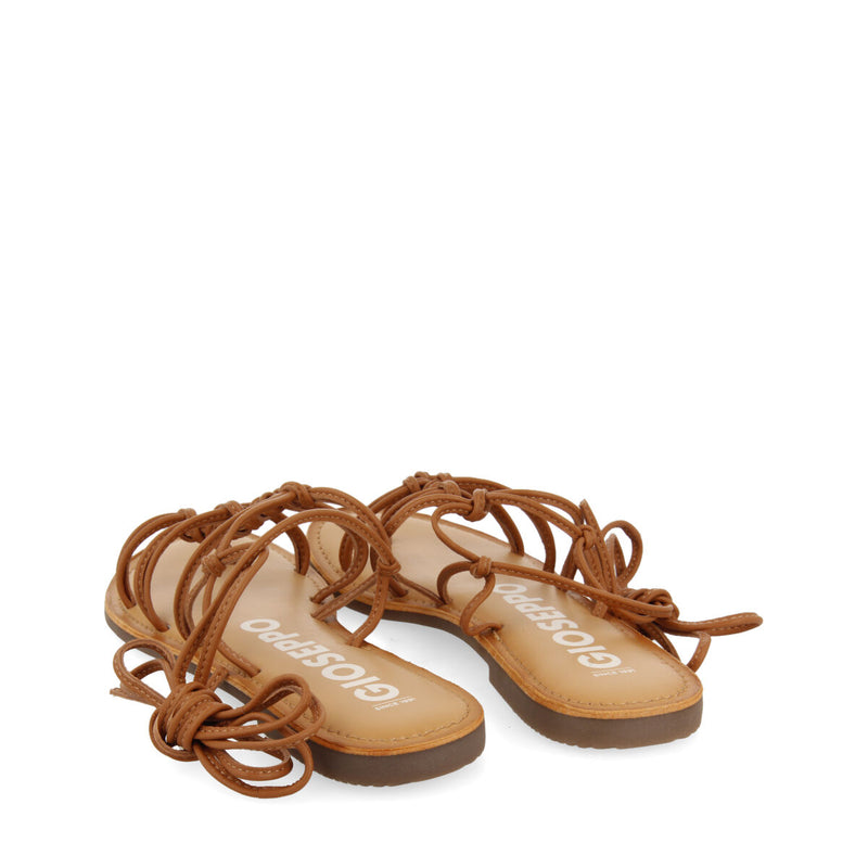 Mambai women's flat tan leather sandals with thin straps and decorative knots