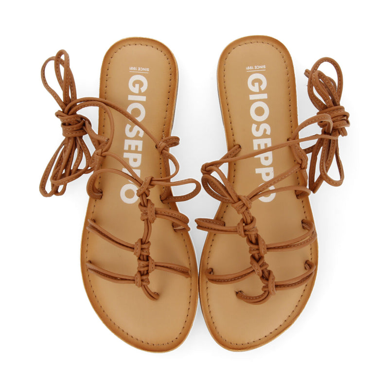 Mambai women's flat tan leather sandals with thin straps and decorative knots