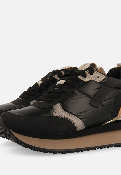 Sneakers noires monochromes rembourrées ornées de détails et talonnette invisible pour femme anif 