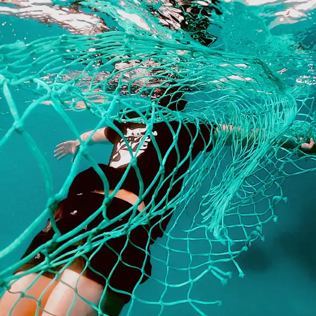 Swimming next to a fishing net